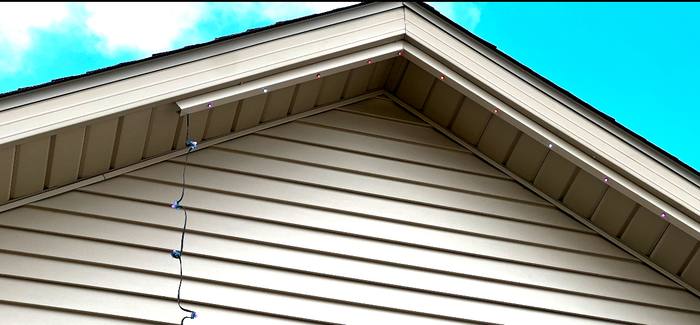 Close-up daytime view of Trimlight channel along a roofline, barely visible