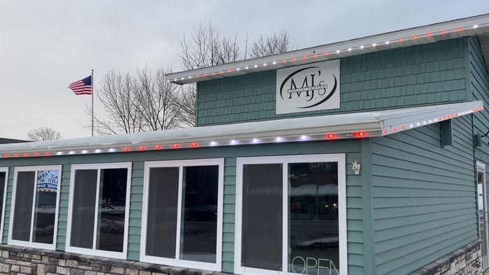 MJ's Burrito Company storefront with red and white Trimlight along the roofline
