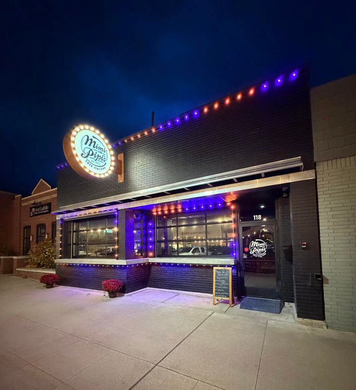 Mimi and Pipi's Casa Italiana restaurant storefront with purple and orange Trimlight around the windows
