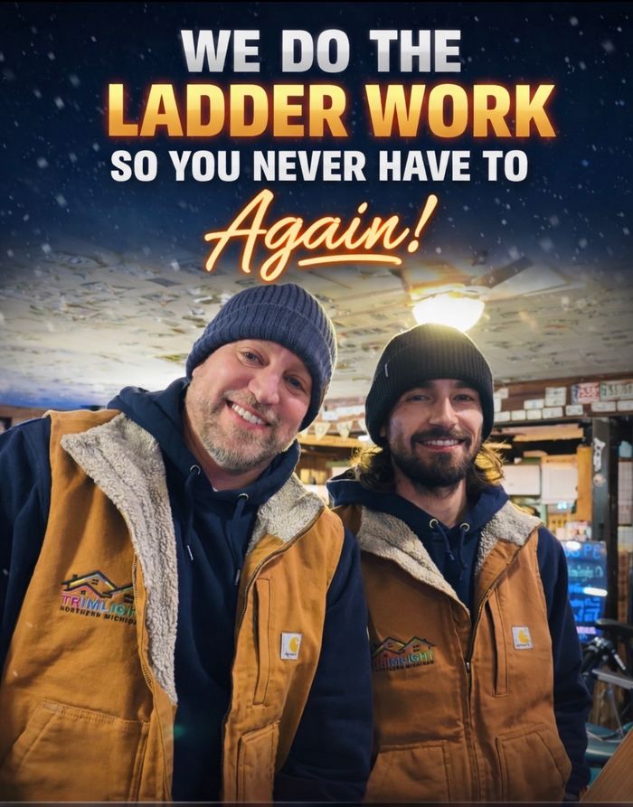 Two Northern Michigan Trimlight installers in branded Carhartt gear, text reads We do the ladder work so you never have to, again!