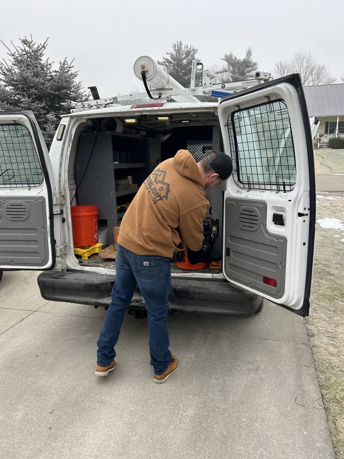 Installer loading tools from the Northern Michigan Trimlight service van