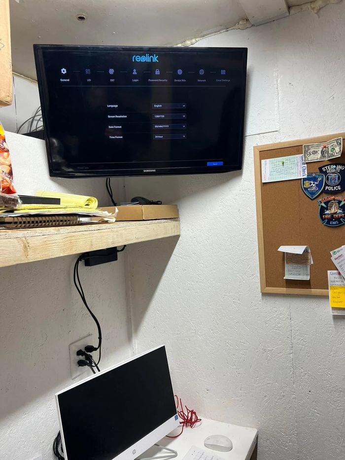 Security system hard drive connected to a TV screen showing the camera setup menu